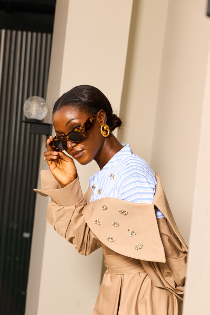 A close view of the embellished collar and sculptural detailing of an Amnas trench coat